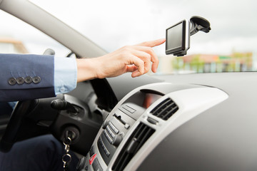 close up of man with gps navigator driving car