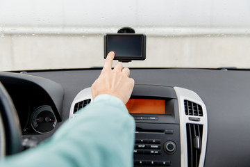 close up of man with gps navigator driving car