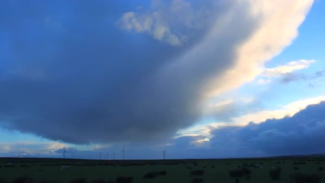 Amazing cloud formations form over a barren landscape.