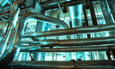 Equipment, cables and piping as found inside of a modern industr