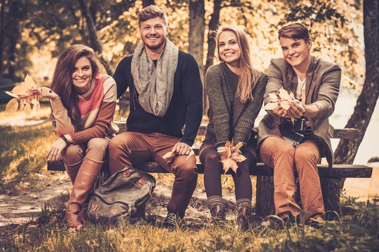 Cheerful Friends In Autumn Park