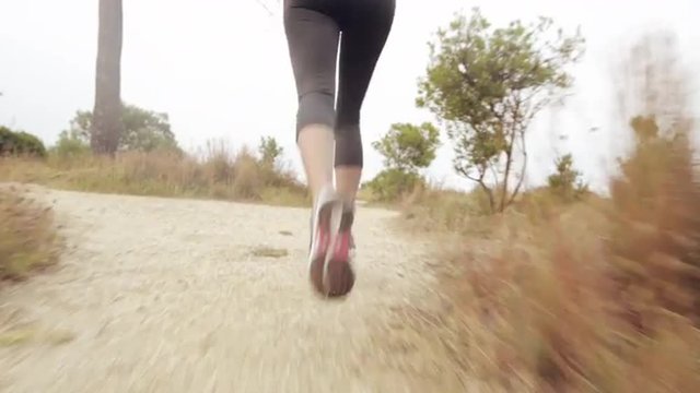 woman running trail close up shoes steadicam shot