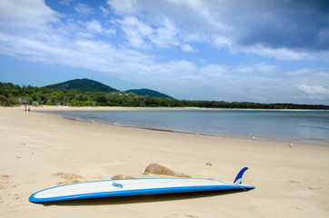 Fototapeta na wymiar Surfboard on a sandy beach