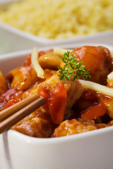 Fried chicken pieces in batter with sweet and sour sauce