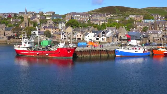 Establishing shot from a boat of the port at Stromness, Orkney Islands, Scotland.