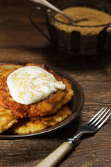 Homemade potato pancakes served with sour cream and brown sugar