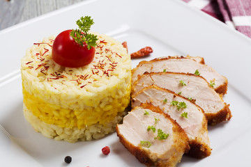 Portion of risotto with roasted chicken.