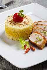 Portion of risotto with roasted chicken.