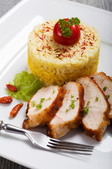 Portion of risotto with roasted chicken.