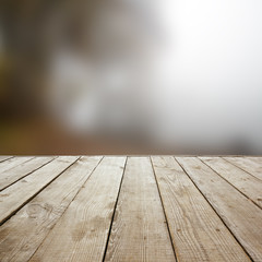 Wooden perspective floor with planks on blurred natural autumn background, can use for display or montage your products. template. Copy space