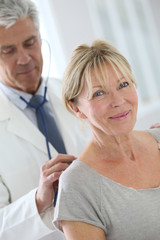 Fototapeta premium Senior woman in doctor's room for consultation