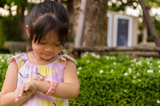 Little Girl Using Smartwatch or Smart Watch / Young Girl with Smartwatch or Smart Watch