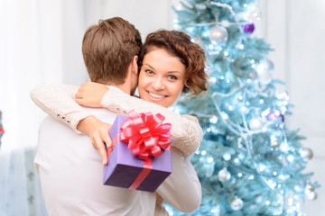 Loving couple holding present 
