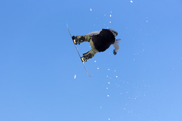 Snowboarder jumps in Snow Park