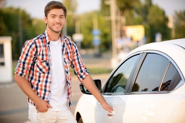 Young man opening his car 