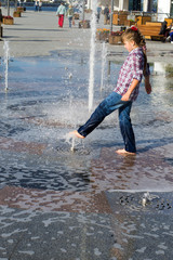 girl playing in the fountain