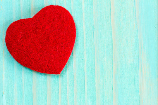 Heart on blue wooden background