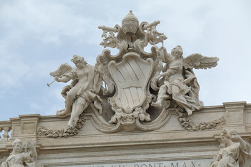 Fototapeta na wymiar Papal Coat of Arms on Palazzo Poli Facade in Rome