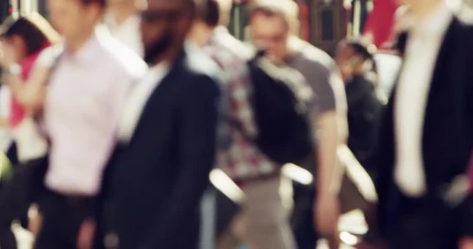 Anonymous crowd of business people walking in city streets london summer 2014