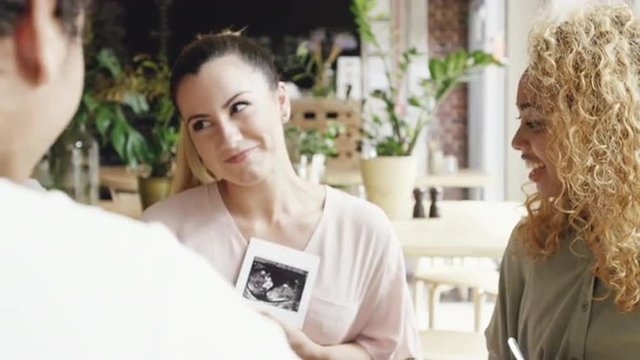 Pregant woman showing baby photograph ulrta sound scan
