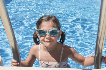 Smiling girl enjoying the pool in summer