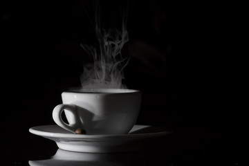 small white cup of Italian coffee with smoke