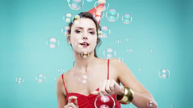 Crazy face woman popping bubble shower slow motion photo booth blue background