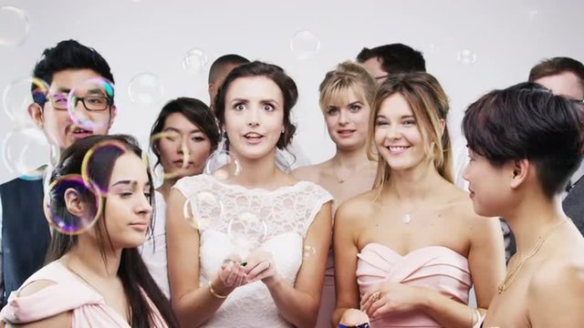 Crazy face mixed race group friends dancing slow motion wedding photo booth series
