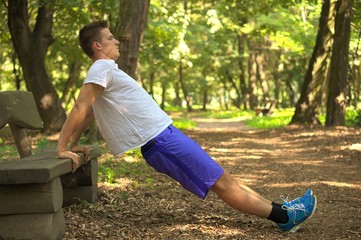 Young man warming up before fitness.