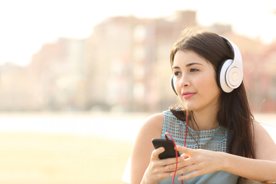 Candid girl listening music with a smartphone