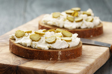 sandwiches with rye bread, cream cheese and marinated cucumbers