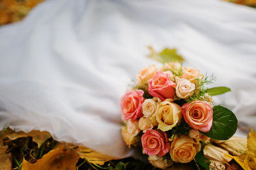 wedding bouquet background wedding dress in yellow autumn leaves