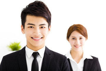 happy business man and woman standing  in office