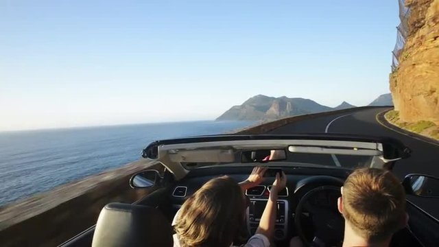 Couple driving convertible car cabriolet cape town south africa steadicam shot