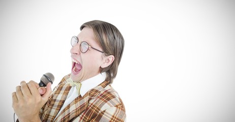 Composite image of happy geeky hipster singing with microphone 