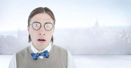Composite image of geeky hipster looking surprised at camera 