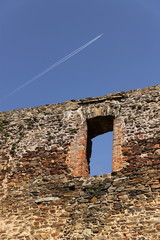 Airplane over the old wall