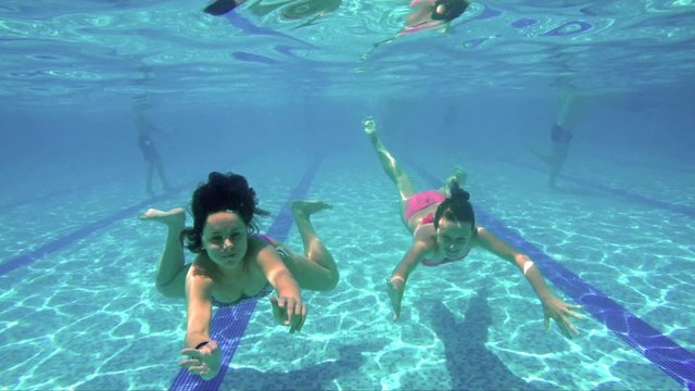 Two kids swimming underwater, SLOW MOTION
