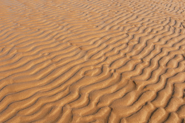Wind patterns on the beach. Natural background of sand in ripple wave pattern.