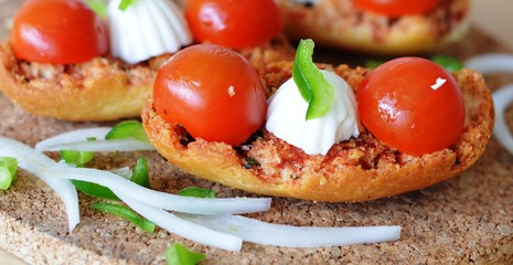 Italian Bruschetta With Mozzarella And Tomato On A Wooden Table