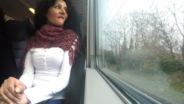Woman looks out of window on train trip during movement. 4k uhd stock footage