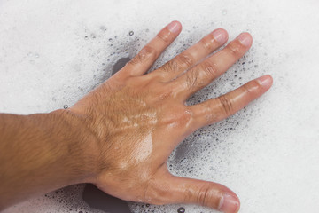 Hand washing clothes with soapy water