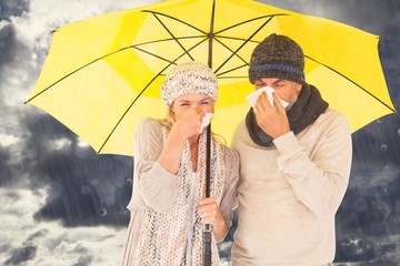 Composite image of couple sneezing in tissue 