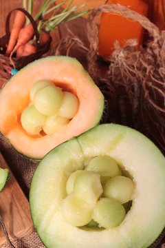 Cantaloupe melon fruit juicy on wood background.