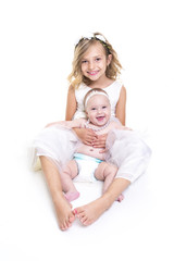 portrait of two sisters in white dresses