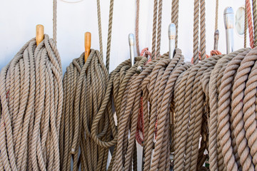 Bundle of various old twisted ropes close up.