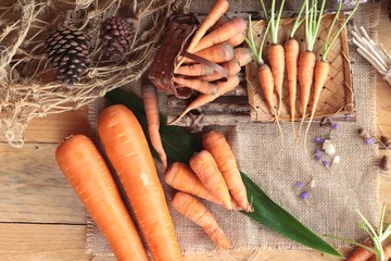 Fresh carrots on the wood background.