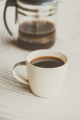 Selective focus point on black coffee in white cup - vintage fil