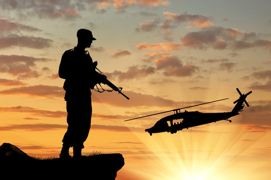 Silhouette of a soldier and helicopter
