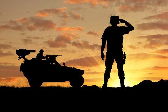Silhouette of a soldier and military vehicle